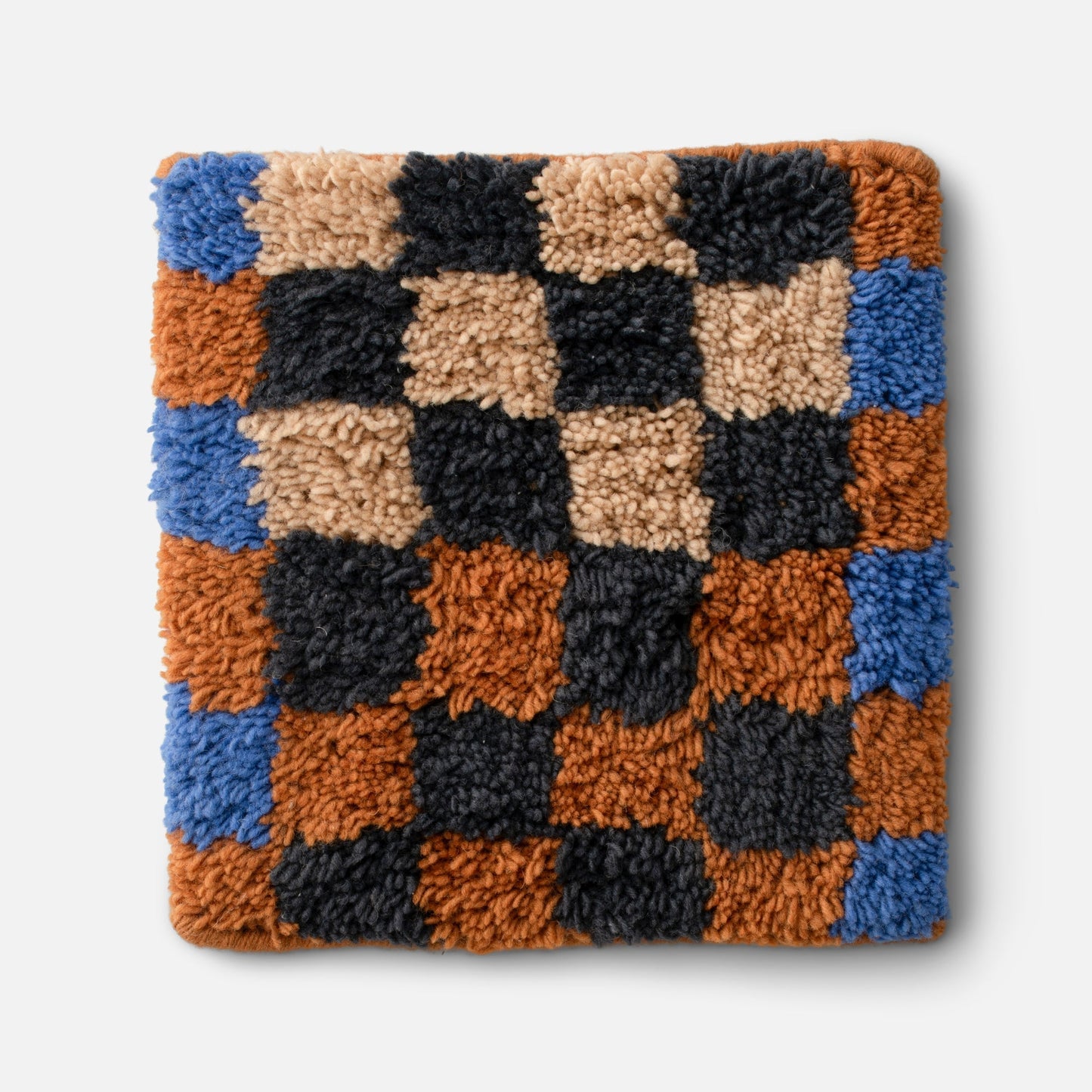 Close-up of Felix shag wool rug showing checkerboard high-pile wool texture in butterscotch, charcoal, and blue on a white background