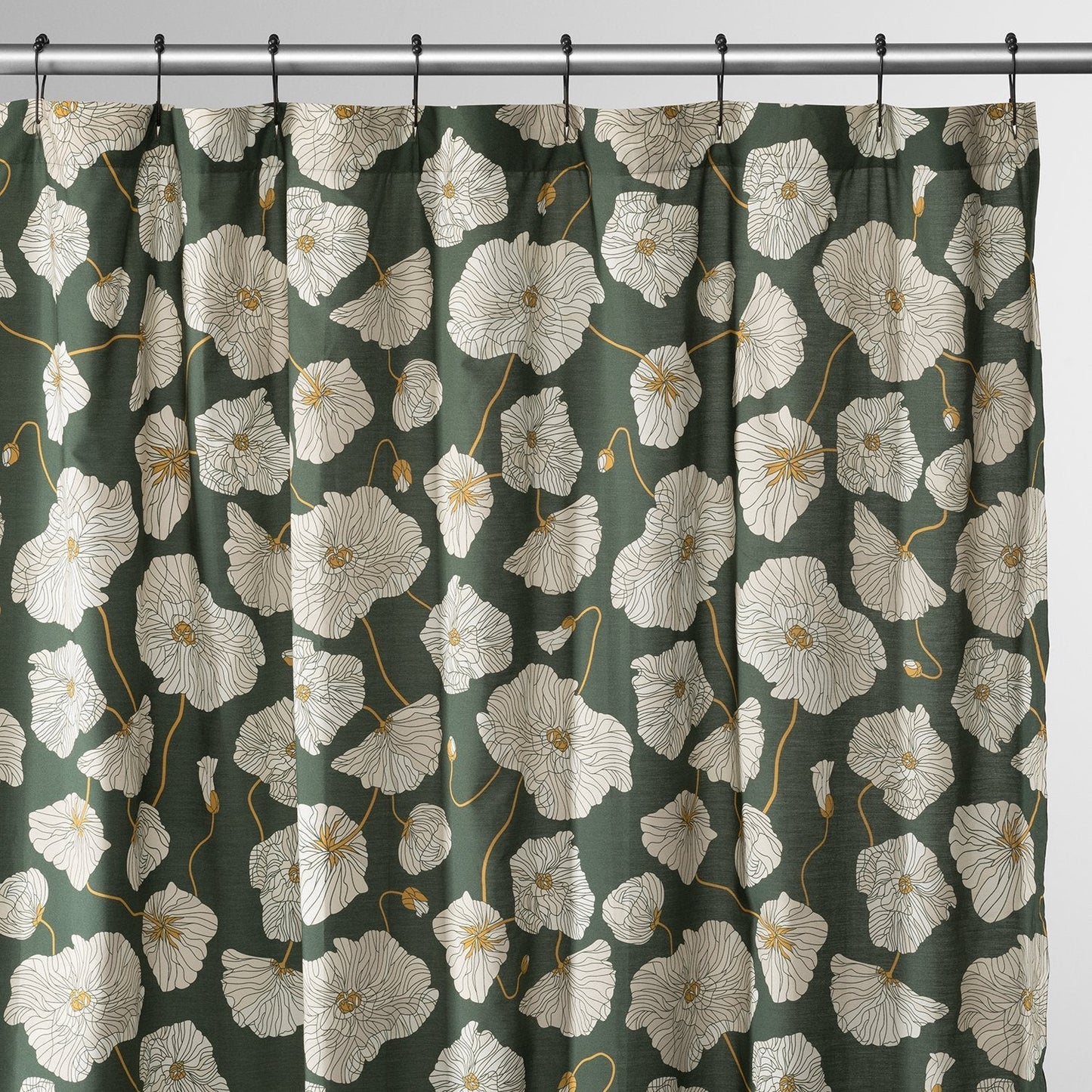 Front view of Blooming Field shower curtain with white poppy pattern and gold stems on green, on silver rod