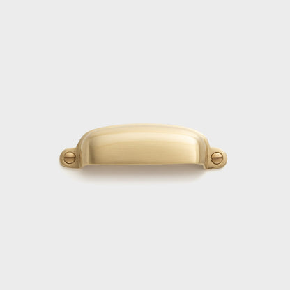 Front view of Brunswick Pull showcasing solid brass construction and exposed mounting hardware against a light gray background