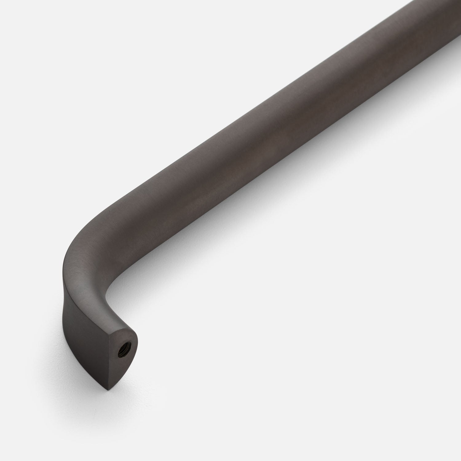 Close-up of Cascade appliance pull showcasing curved end and visible mounting hole with a white background
