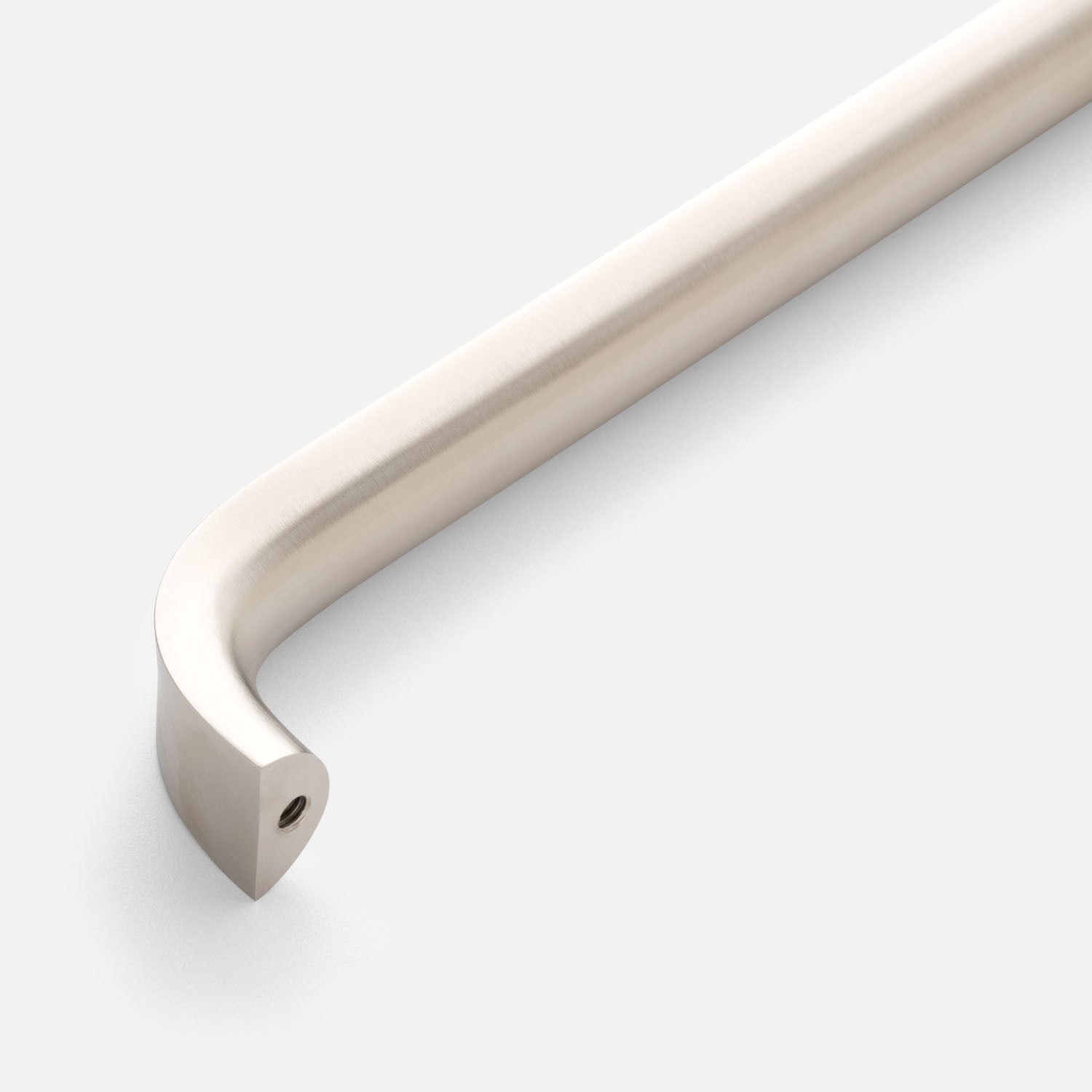 Close-up angled view of Cascade Appliance Pull showcasing its curved bar and visible mounting hole against a light background