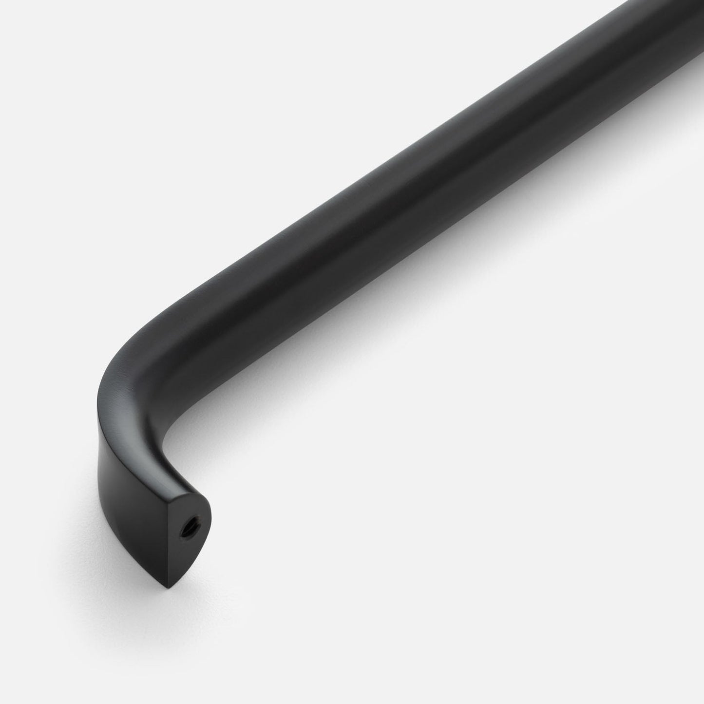 Angled close-up of Cascade Appliance Pull showcasing its curved black bar and mounting end on a white background