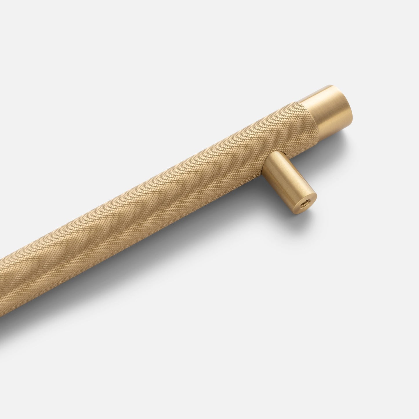 Angled view of Knurled Appliance Pull showcasing its textured cylindrical grip and perpendicular mounting post on a light gray background