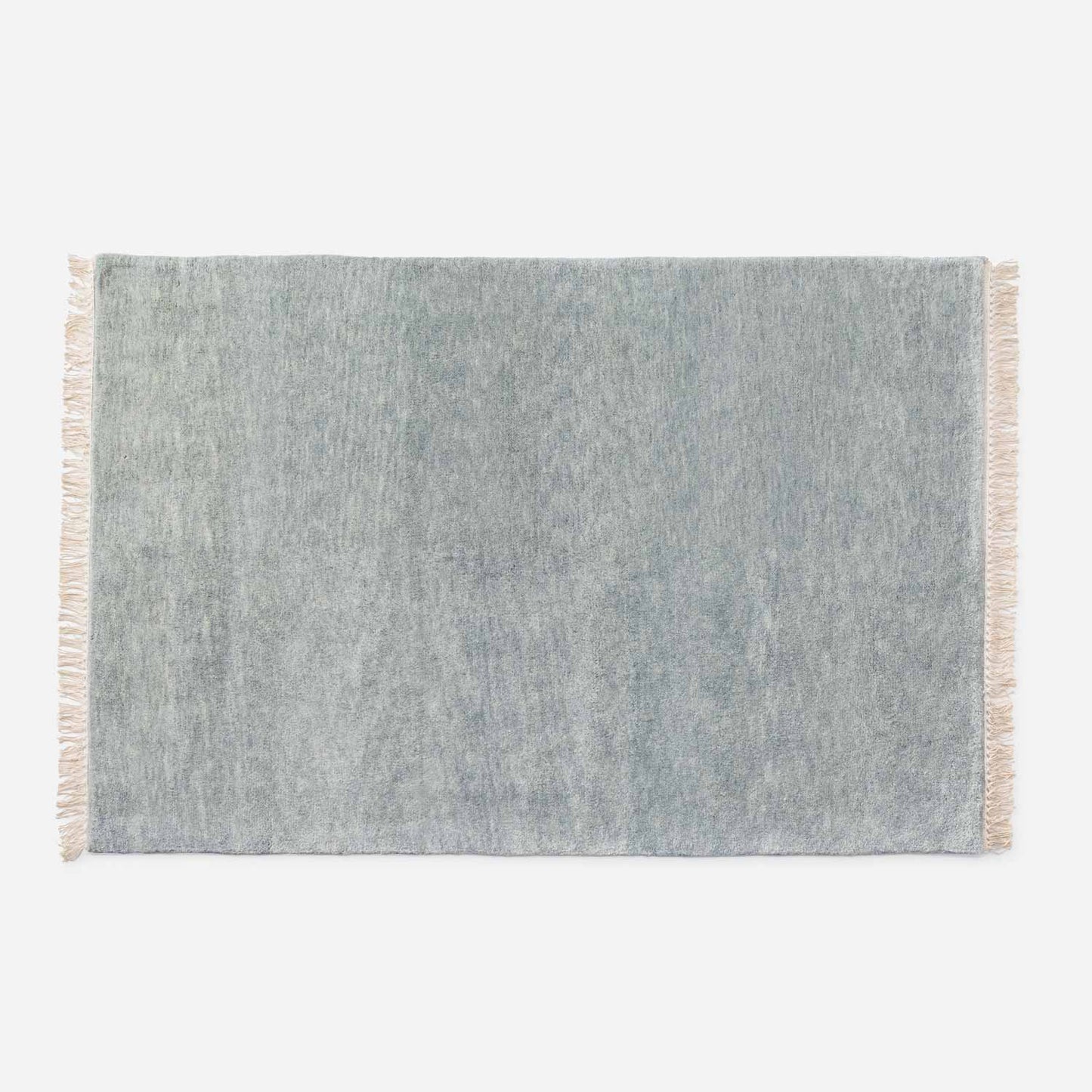 Top-down view of Mesa Wool Rug showcasing hand-loomed 100 percent New Zealand wool pile and fringe on a white background